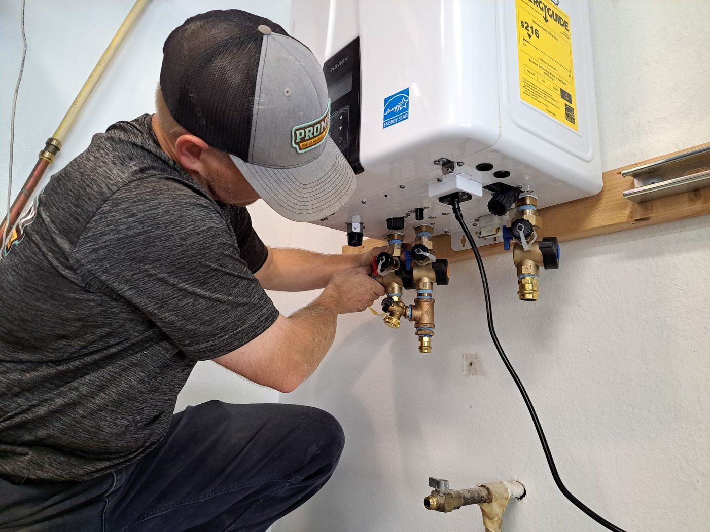 Technician repairing tankless heater with diagnostic software